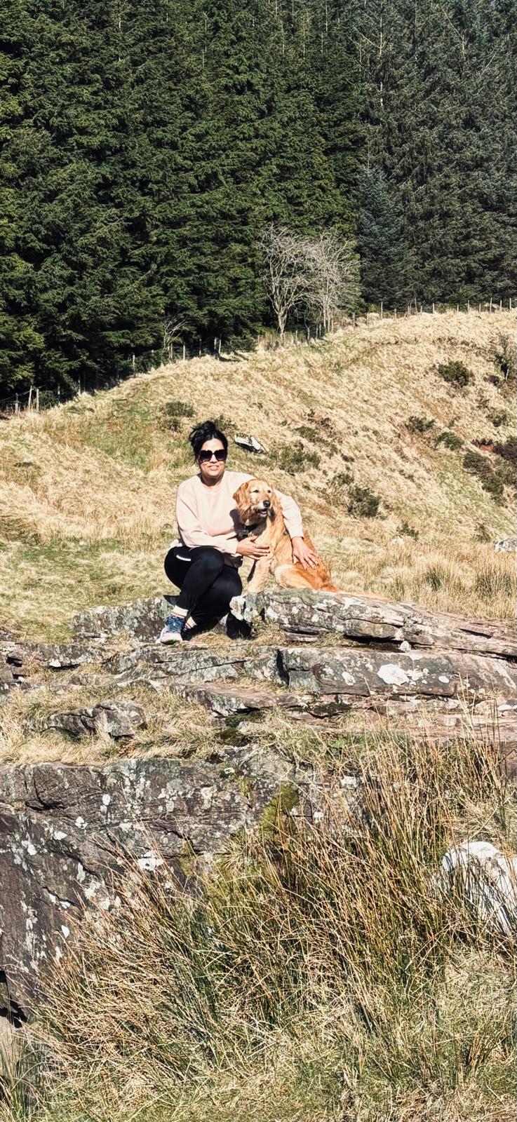 Girl and dog with mountain background